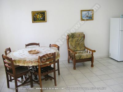 apartment caprice mauritius dining room view
Caprice Apartment dining room. Has a dining table with five wooden chairs around it. The dining room leads to the kitchen.
Keywords: Caprice Apartment, dining room, table, chairs, kitchen, fridge
