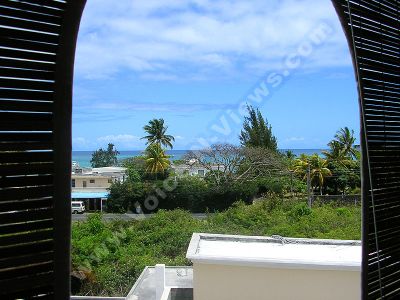 apartment caprice mauritius sea view from balcony
Caprice Apartment sea view from balcony. Through the blinds on the balcony you can see the view of the sea and the trees. 
Keywords: Caprice Apartment, balcony, sea, view, blinds, vegetation, palm trees