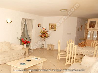 apartment le grenadier mauritius living room and dining room view
Le Grenadier Apartment living and dining rooms. The living room has sofas, a coffee table, side tables one with a telephone. There is a dining table and chairs. Arrangements of flowers decorate and complete the rooms.
Keywords: Le Grenadier Apartment, living room, dining room, sofas, coffee table, dining table, chairs, telephone, flowers