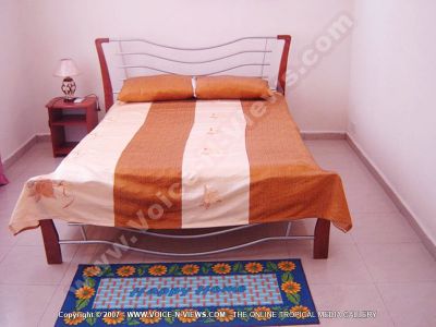 standard apartments trou d?ǨѢeau douce mauritius ref 180 bedroom view
Standard Apartments Trou D?ǨѢeau Douce Mauritius Ref 180. The bedspread on the double bed is white and red. There is a bedside table, a lamp and a blue mat on the floor at the end of the bed.
Keywords: Les Badamiers Apartment, bedroom, bed, table, lamp, white, red, mat, blue