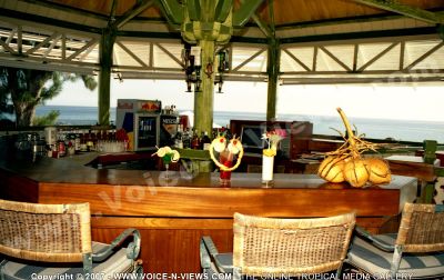 2 star hotel klondike hotel bar
Enjoy different Mauritian style cocktials at the 2* Klondike Hotel bar. Different drinks, cocktails and juices are served here. A bunch of coconuts are displayed on the bar. The bar has a beautiful view of the sea.
Keywords: 2* bar, drinks, cocktails, fruit, coconuts, sea