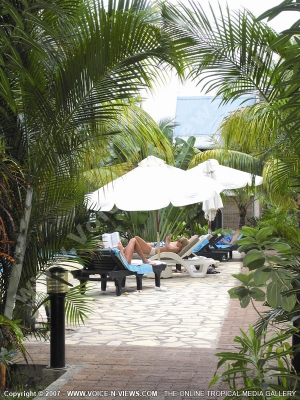3 star hotel le palmiste hotel mauritius guests relaxing in sunbed near the pool
