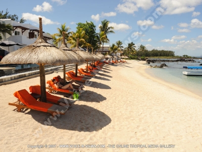 le recif hotel mauritius couple relaxing on sun bed at the beach
