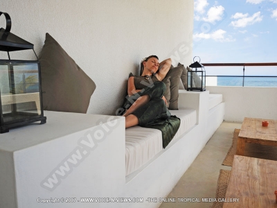 le recif hotel mauritius lady relaxing on the balcony with sea view

