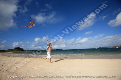four seasons resort mauritius at anahita kid flying kite watermark view
