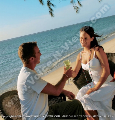 pearle beach resort & spa mauritius couple having champagne on the beach
