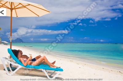 pearle beach resort & spa mauritius couple relaxing in sunbed
