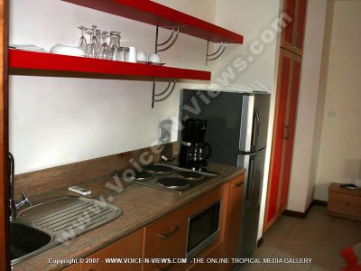 superior villa bain boeuf ref 162 mauritius kitchen view
Superior Villa Bain Boeuf Ref 162 kitchen. Is equiped with stove, oven, fridge, coffee maker, glasses, plates, teacups, washing sink and cupboards. The kitchen looks into the dining and living room.
Keywords: superior villa bain boeuf ref 162, kitchen, fridge, stove, oven, coffee maker, sink, plates, glasses, teacups