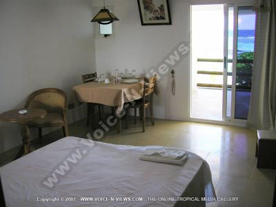 apartment cilaos mauritius bedroom view
Cilaos Apartment bedroom. Has a double bed, a dining table with chairs. The table is set withplates, knives and forks, glasses and teacups. The bedroom has a wardrobe for guests clothing, and a dressing table. The room leads out onto a balcony that overlooks the sea.
Keywords: Cilaos Apartment, bedroom, bed, chairs, dining table, balcony, sea