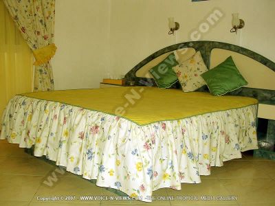 apartment latanier mauritius double room view
Latanier Apartment double bedroom. Has a double bed with a bedside table on each side. The room is decorated in green, yellow, white. The bedspread is yellow and wgite with small pink, blue and yellow flowers on it. There are two lights on the wall above the bed.
Keywords: Latanier Apartment, double room, double bed, bedside table, green, yellow, white, pink, blue, flowers, lights