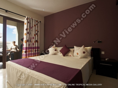 grand bay suites mauritius bedroom and balcony view
