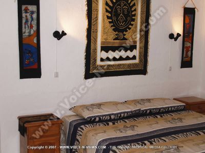 guest house tropicana mauritius bedroom view
Tropicana guesthouse bedroom view.  It is a small one bed roomed beach flat.  There is a double bed in the room with a bedside table on either side of it and a zebra printed quilt. There is art on the walls of the room.
Keywords: Tropicana guesthouse, bedroom, art, wildlife, bedspread, zebra, bedside table, lights