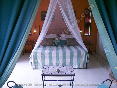 lodge lakaz chamarel mauritius bedroom view
Lakaz Chamarel bedroom view. The room is decorated in blue and white. It has a double bed with a bedside table and lamps on either side, as well as a mosquito net, and a table in the centre of the room as well as a chair.
Keywords: Lakaz Chamarel, bedroom, double bed, mosquito net, blue, white
