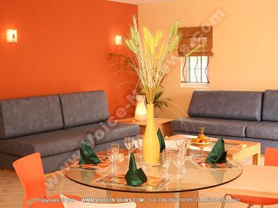 villa four heavens mauritius livingroom and dining room view
Four Heavens Villa living and dining room view. The kitchen looks onto the living and dining rooms. In the living room there are grey sofas and a coffee table. The dining table is set with place mats, glasses, cutlery, napkins.
Keywords: Four Heavens Villa, living room, dining room, grey, sofas,