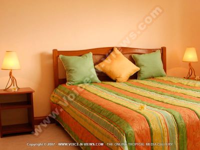 villa four heavens mauritius room view
Four Heavens Villa room view. The bedroom is decorated in peach and green. There are two bedside tables; one on either side of the bed and with a lamp on each. 
Keywords: Four Heavens Villa, room, green, peach, bedside tables, lamps
